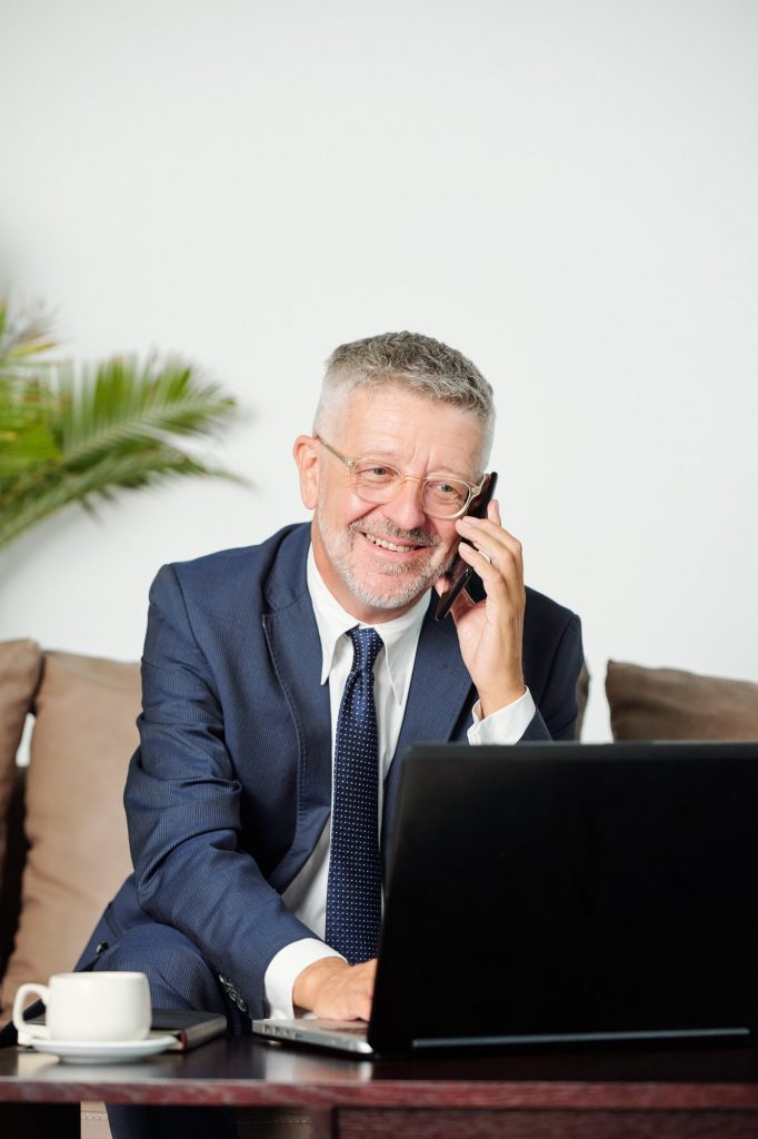 Smiling businessman calling on phone